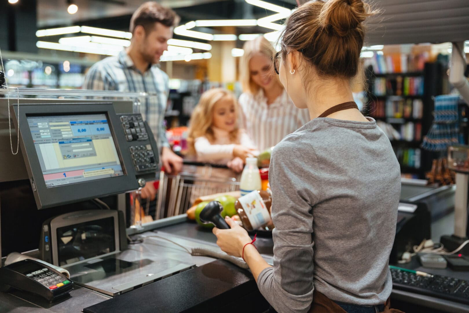 beautiful-family-standing-at-the-cash-counter